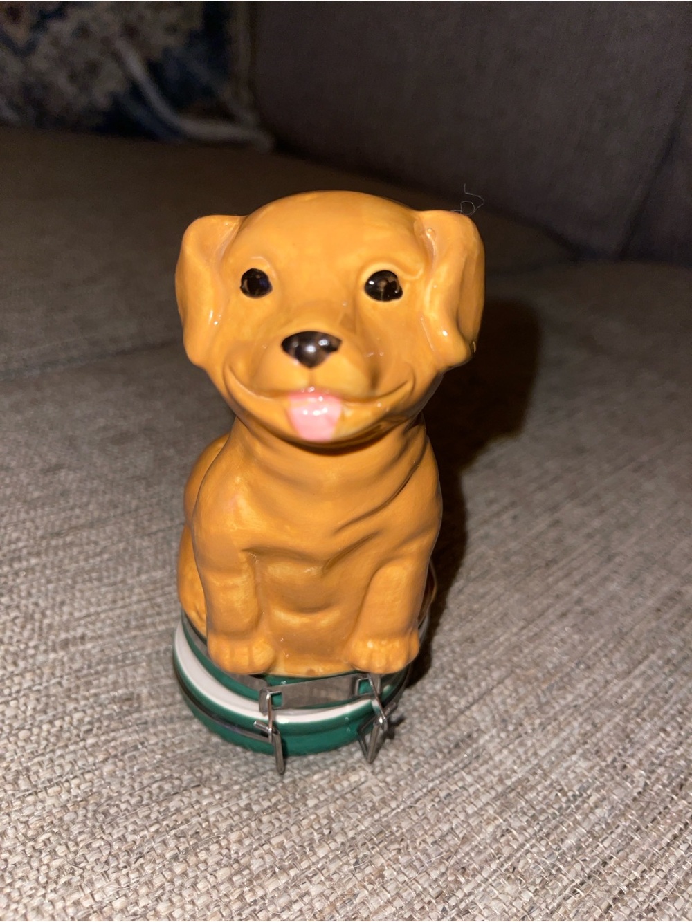 Ceramic dog figurine that has storage in the bottom.